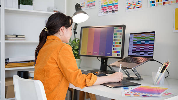 istock Female graphic designer analyzing color samples for project in a creative studio.Female graphic designer analyzing color samples for project in a creative studio. 2211775876