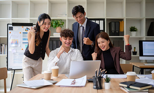 istock Excited business team celebrating success at work. Corporate motivation and teamwork concept. 2211776400
