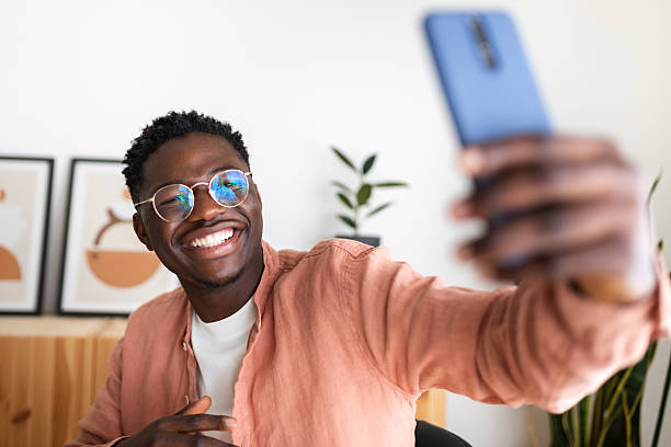istock Cheerful young man taking a selfie with his smartphone 2211778832