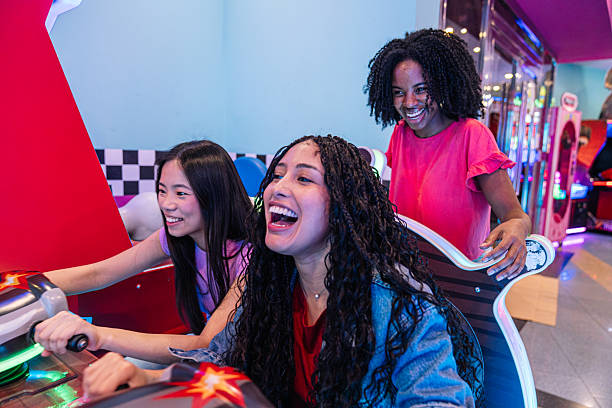 istock Young women having fun playing arcade game together 2211779153
