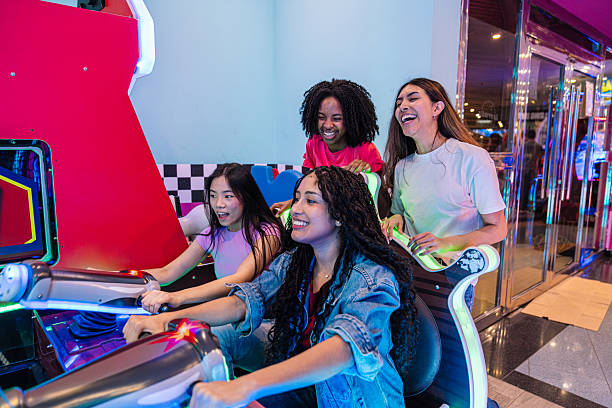 istock Young women having fun playing arcade game together 2211779476
