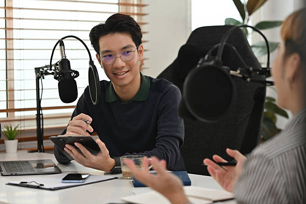 istock A podcast host and guest engage in a lively discussion in a professional home studio, creating an engaging and informative conversation 2211780071