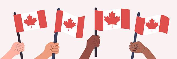 istock People of different races hand raising flags of Canada 2211780106