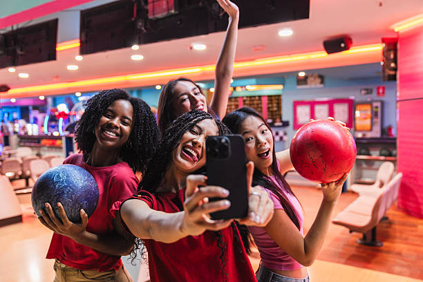 istock Cheerful friends taking selfie while bowling and having fun 2211783467