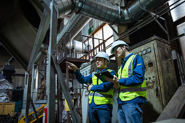 istock Two Asian workers discussing work in heat treatment workshop 2211783894