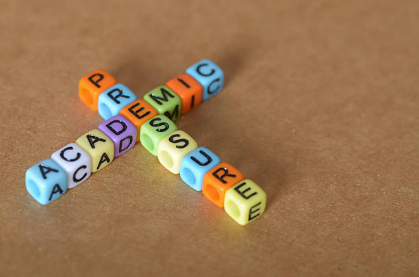 istock Stress in Education Depicted with Bright Lettered Dice Spelling ACADEMIC and PRESSURE 2211785555