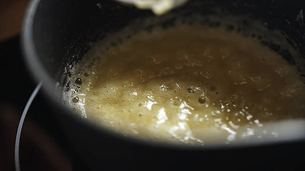 istock Female chef preparing bechamel sauce, stirring in bowl. 2211787700