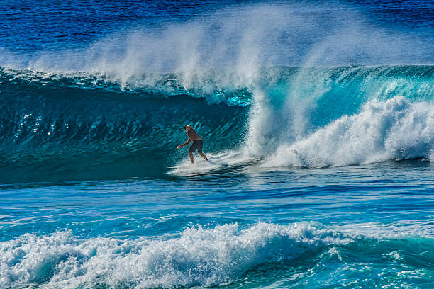 Surfer on perfect wave in the barrel
