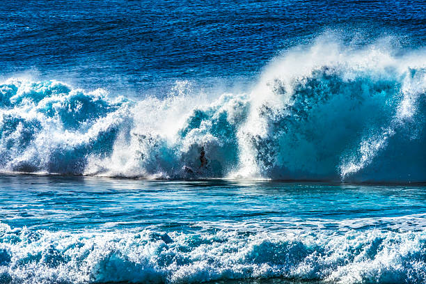 Colorful Surfer Green Room Large Wave Banzai Pipeline Pipeline North Shore Oahu Hawaii. Huge Waves Over Shallow Reef create tubes, large hollow curls of water that surfers can ride. The shallow reef creates a dangerous beautiful place to surf.