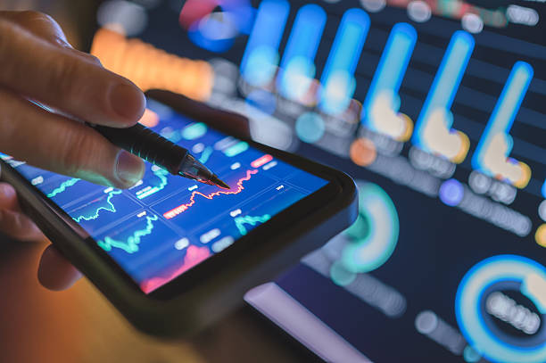 istock fintech user engaging with smartphone and tablet multiple financial dashboards on portable screens simultaneously synchronized trading apps with cryptocurrency analytics 2211789263