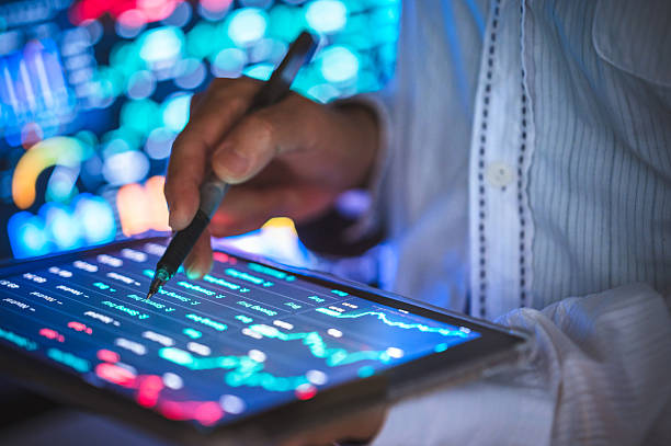 istock Finger gesture pointing at real-time financial data on transparent stock trading  on digital investment dashboard with economic trend and market forecast 2211789302
