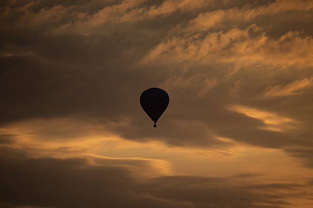 istock Hot Air Balloon Silhouetted Against Moody Sunset Sky 2211792627