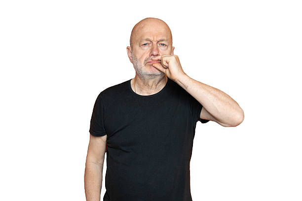 A man making the gesture of keeping his mouth shut