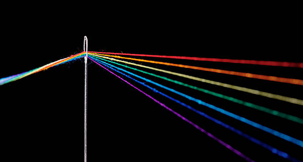 istock multi-colored threads for sewing in the form of a rainbow pass through an antique needle on a black background 2211799594