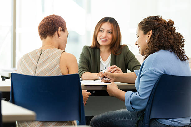 istock Three Women in Casual Clothing Having a Discussion 2211805905