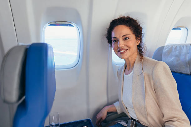istock Elegant businesswoman smiling during flight in first class 2211808797