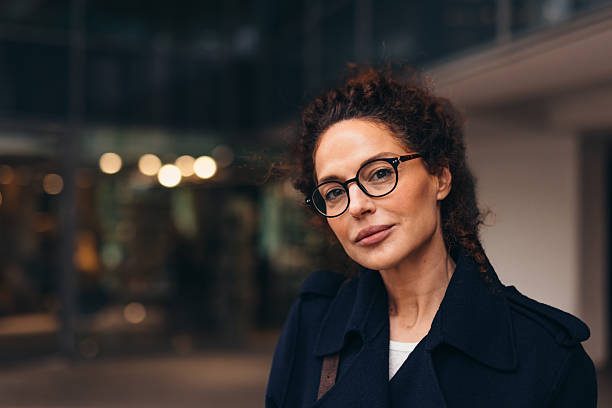 Confident mature businesswoman looking at camera in urban setting
