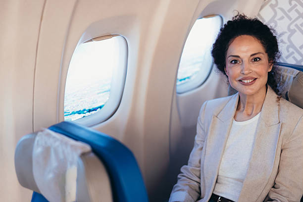 istock Smiling businesswoman enjoying comfortable flight in first class 2211809129