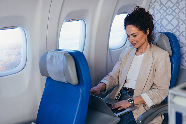 istock Businesswoman working on laptop during flight on airplane 2211809139