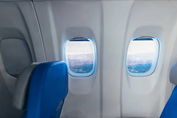 istock Airplane portholes showing aerial view during flight 2211809154