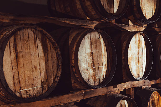 istock Oak barrels storing wine in a winery in a warehouse. 2211810061