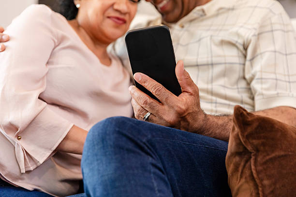 istock Senior Couple Using Smartphone Together at Home 2211810647