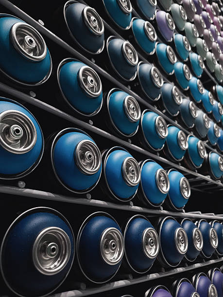 istock Rows of blue spray cans on racks. 2211811028