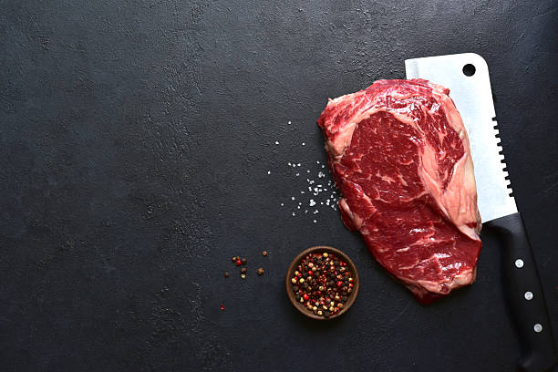 istock Raw organic marbled beef steak with ingredients for cooking . Top view with copy space. 2211826928