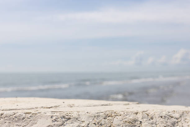 Rocky surface in foreground with soft seascape background perfect for showcasing products or branding mockups.