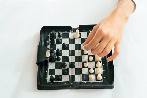 istock Child hand´s  playing chess game on a small magnetic chessboard 2211832849