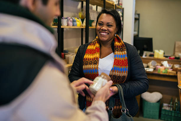 istock Customer interacting with a vendor in a candle shop 2211837019