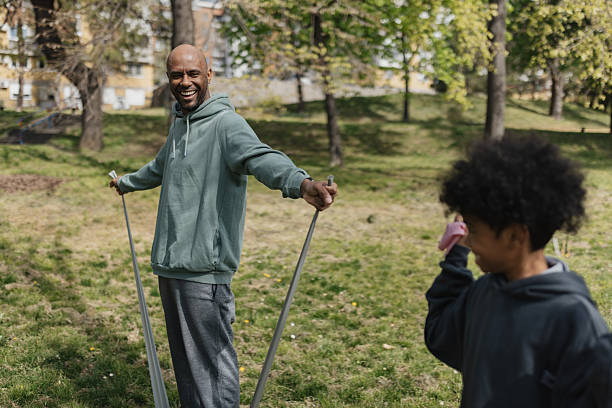 istock Smiling Child and Elderly Man with Resistance Bands 2211837543