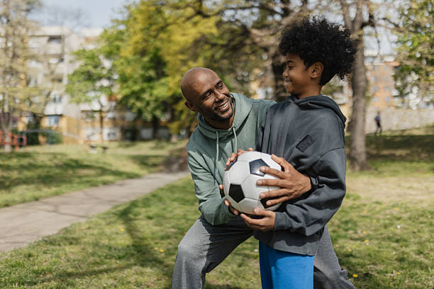 istock Father and son sharing smile over soccer ball. 2211837578