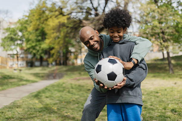 istock Joyful embrace after a successful soccer play. 2211837586