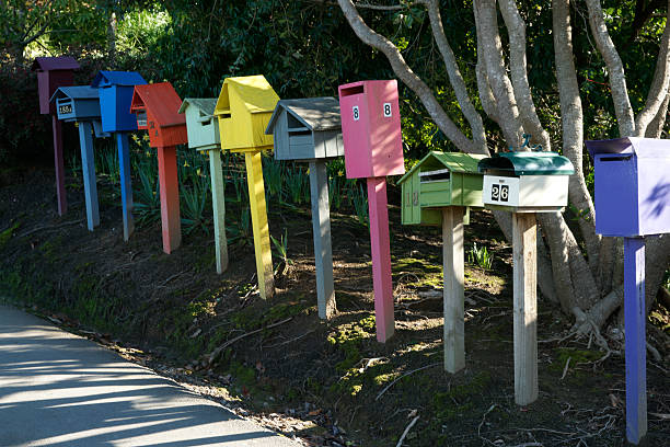Tauranga New Zealand - August 23 2010; Letter boxes different colours and styles in row along road.