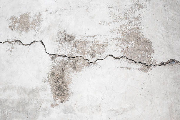 istock Grunge cracked concrete wall texture abstract background 2211843124
