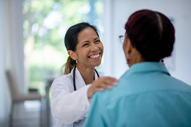 istock Doctor Smiling While Comforting a Patient in a Medical Setting 2211844095