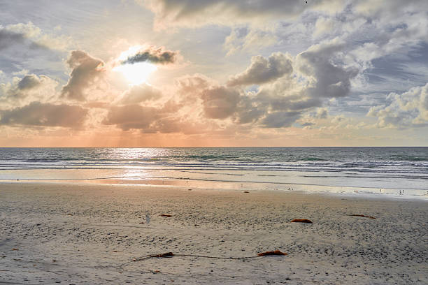 istock Tranquil beach sunrise with sandy shore and dramatic morning sky 2211844259