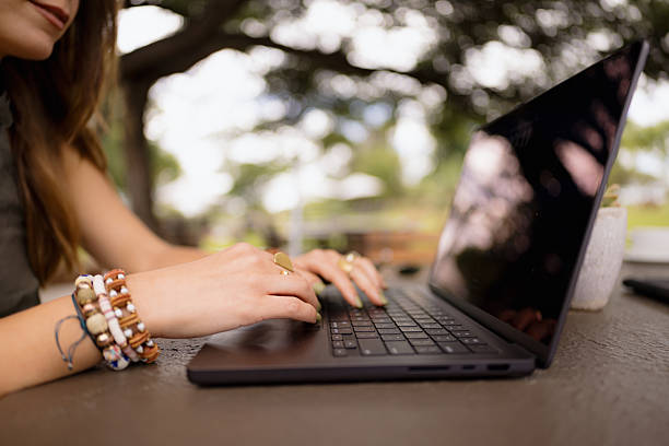 istock Freelancer woman is working on a laptop outdoors in summer 2211844299