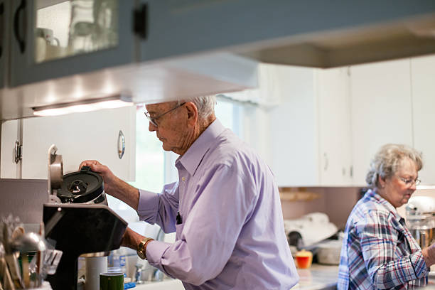 istock Senior Adults Making Coffee in home kitchen 2211845304