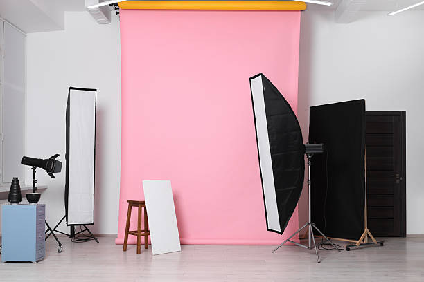 istock Pink photo background, stool and professional lighting equipment in studio 2211845362