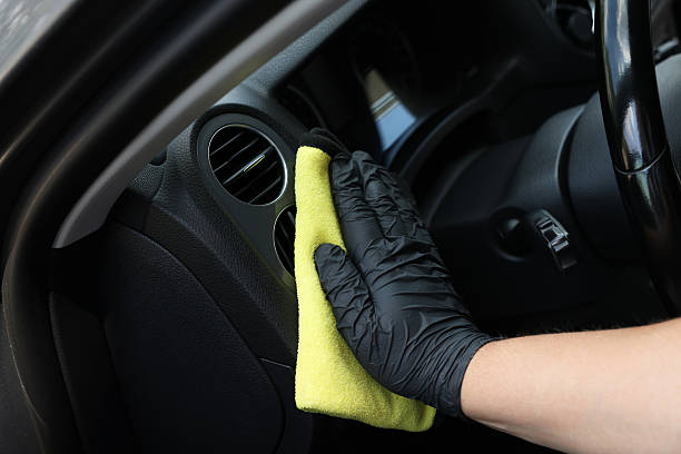 istock Man cleaning car interior with rag, closeup 2211845743