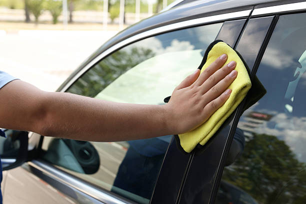 istock Man wiping car window with yellow rag, closeup 2211845748