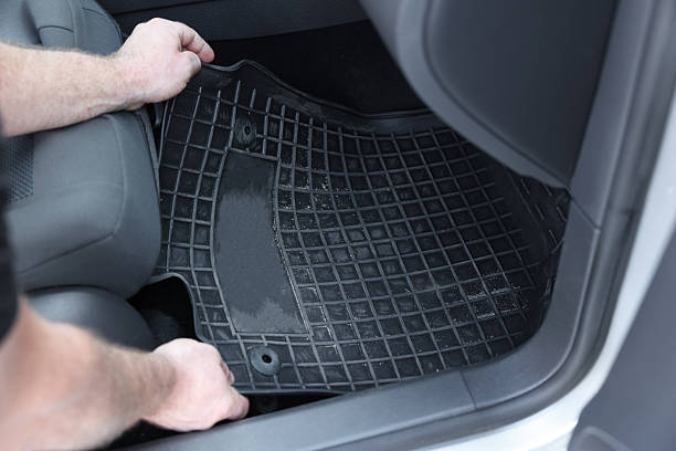 istock Man taking black rubber car mat from auto, closeup 2211845767