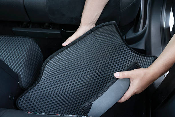 istock Man taking grey rubber car mat from auto, closeup 2211845809