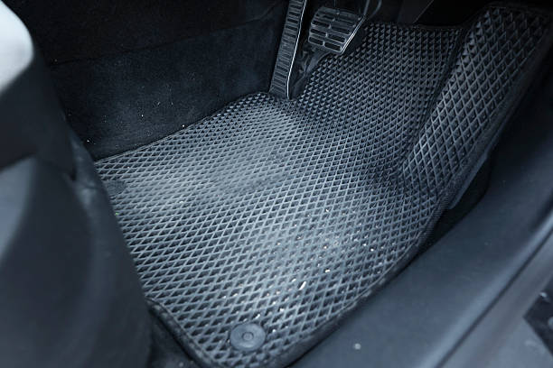 istock Dirty grey rubber car mat in auto 2211845826