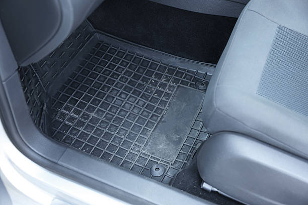 istock Black rubber car floor mat in auto 2211845828