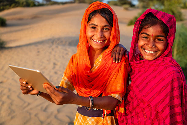 istock Happy Gypsy Indian girls using a digital tablet, India 2211845873