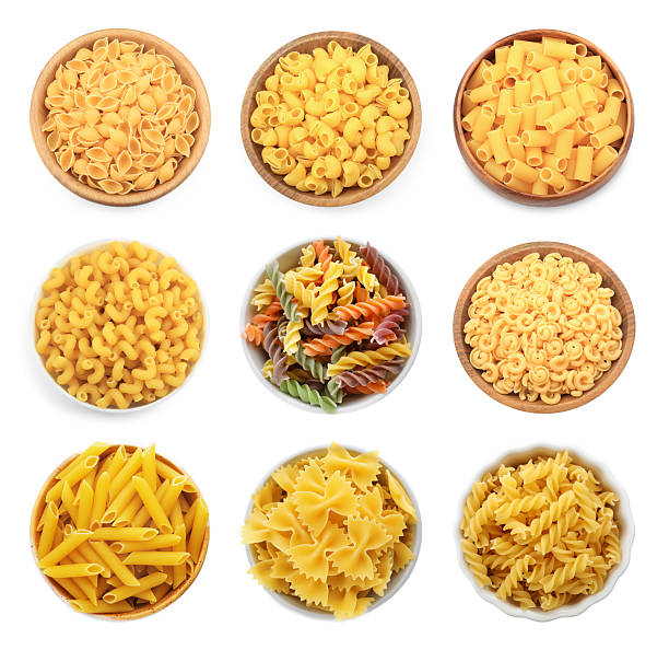 istock Different types of pasta in bowls isolated on white, top view 2211845903