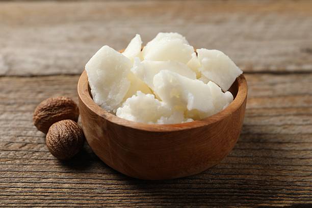 istock Natural shea butter and nuts on wooden table, closeup 2211846760